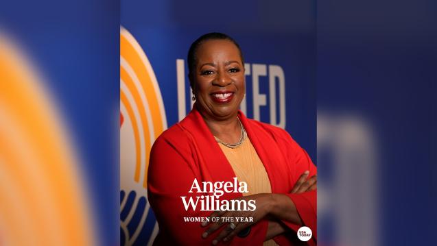 Angela F. Williams posed in front of a United Way logo with "Woman of the year" written on it