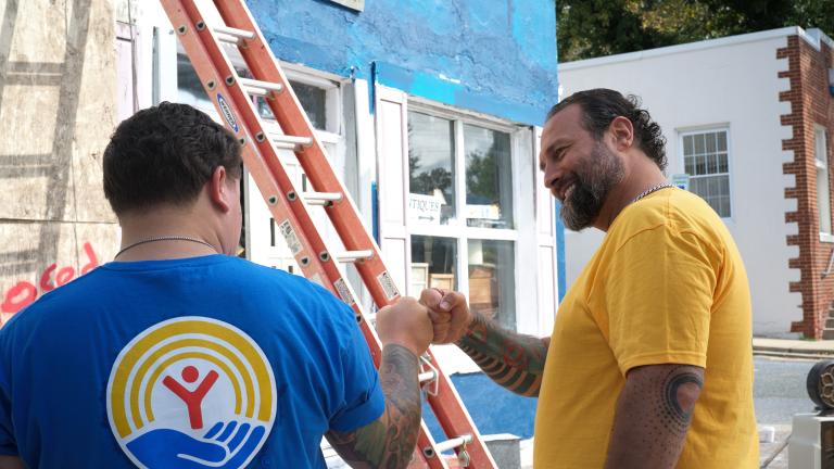 Two people working outside celebrate